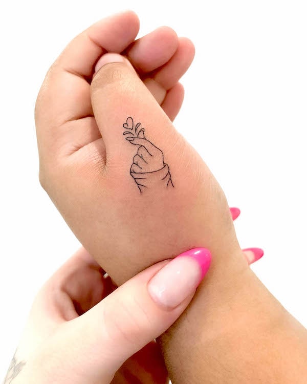 Tatuaj dragut cu inima cu degetul pe mana mica de @joannamroman